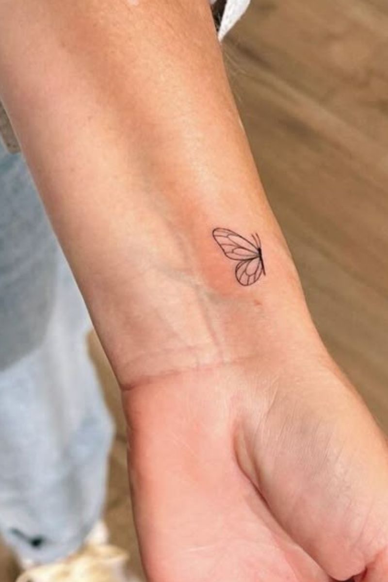 Half a butterfly tattoo on a girls wrist 