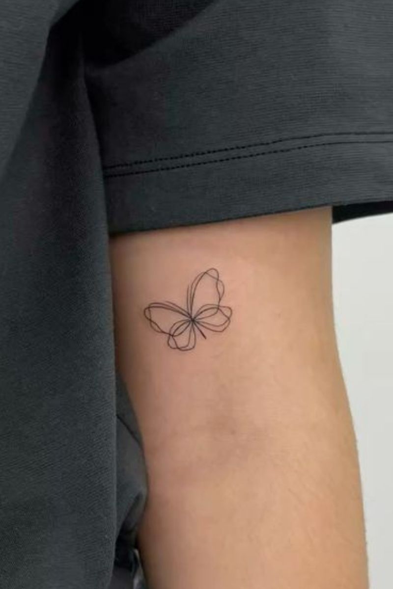 A double lined small butterfly tattoo
