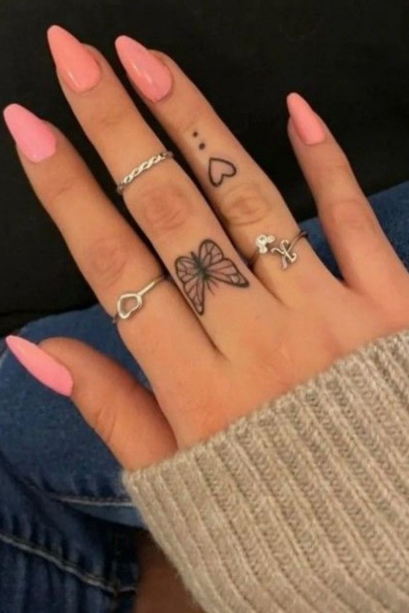 A finger tattoo of a butterfly