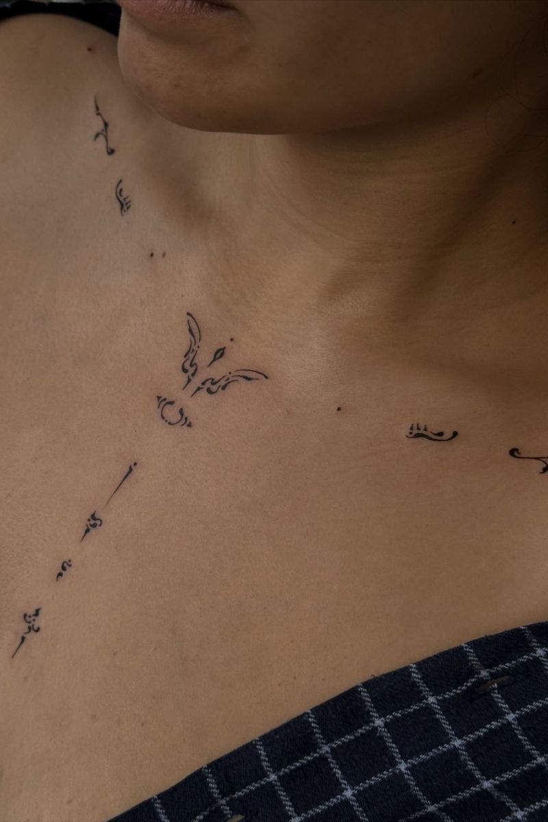A symmetrical collarbone tattoo that goes down the chest 