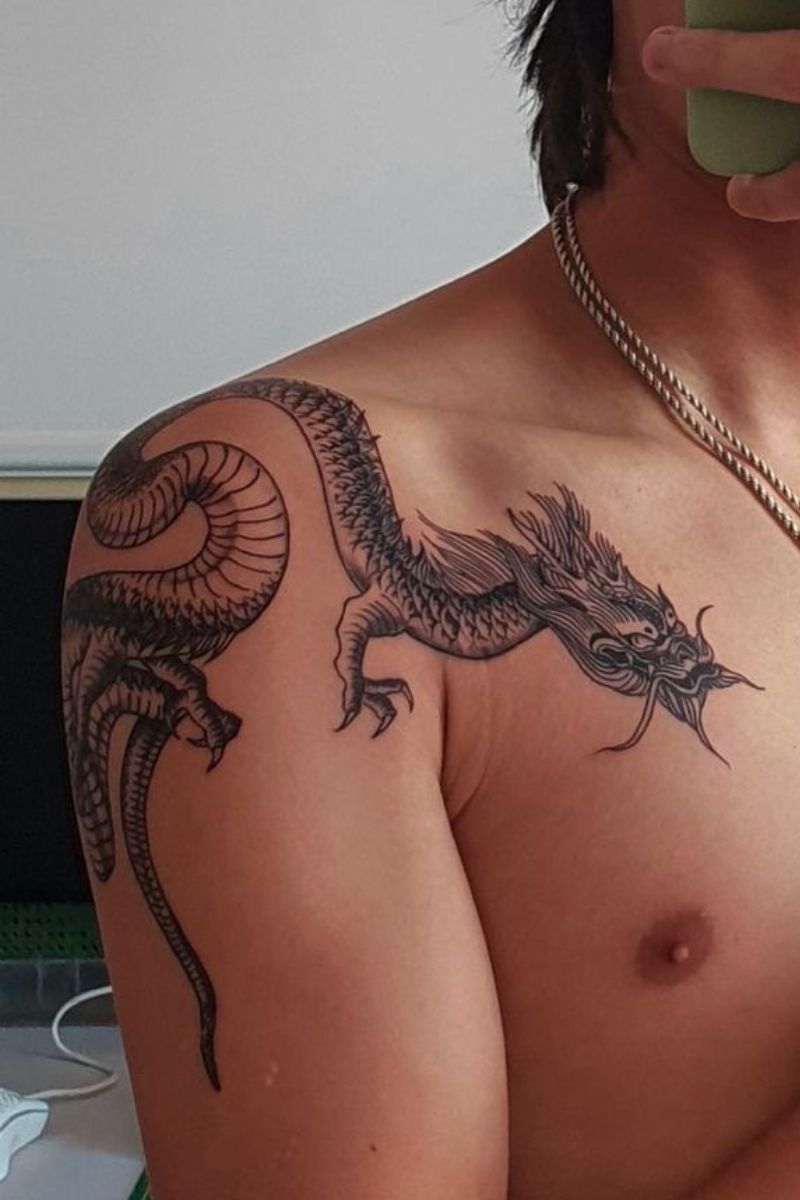 A perched dragon tattoo on a shoulder
