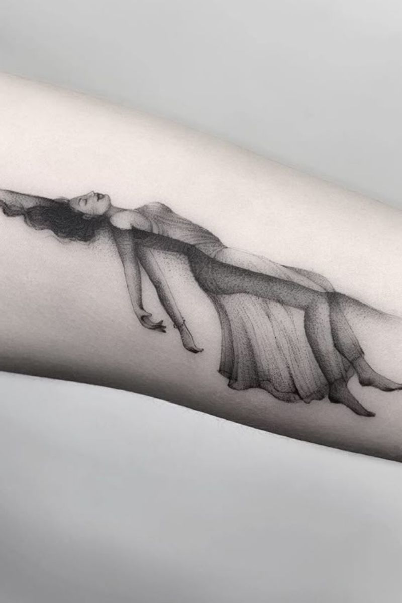 Tattoo art of a woman floating on water