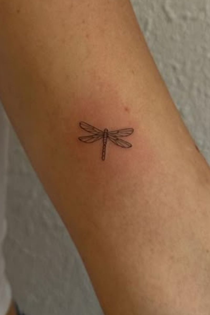A small dragonfly tattoo