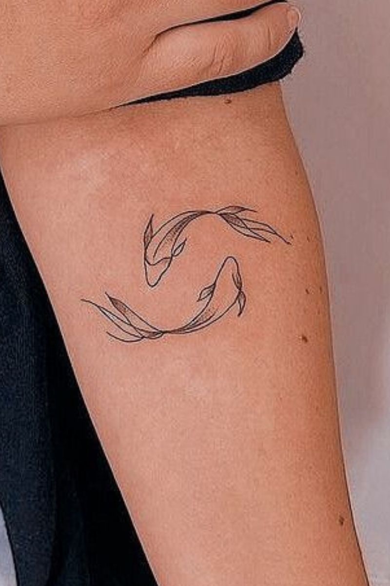Koi fish swimming in a circle tattoo.
