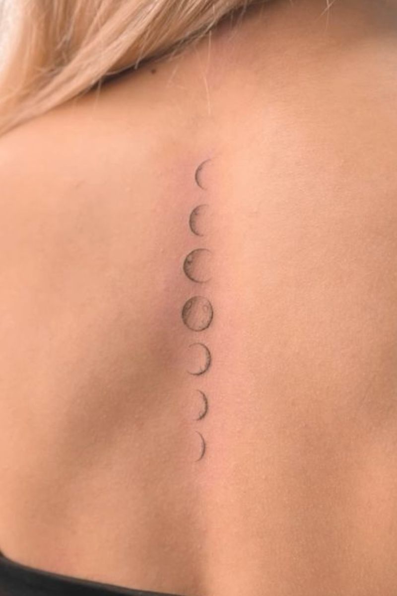 A girl with the moon phases tattooed on her back