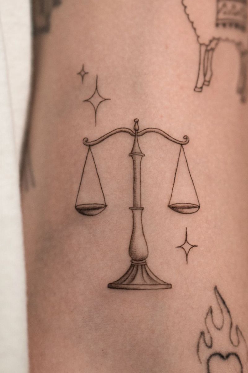 Balancing scales tattoo to symbolize balance and growth
